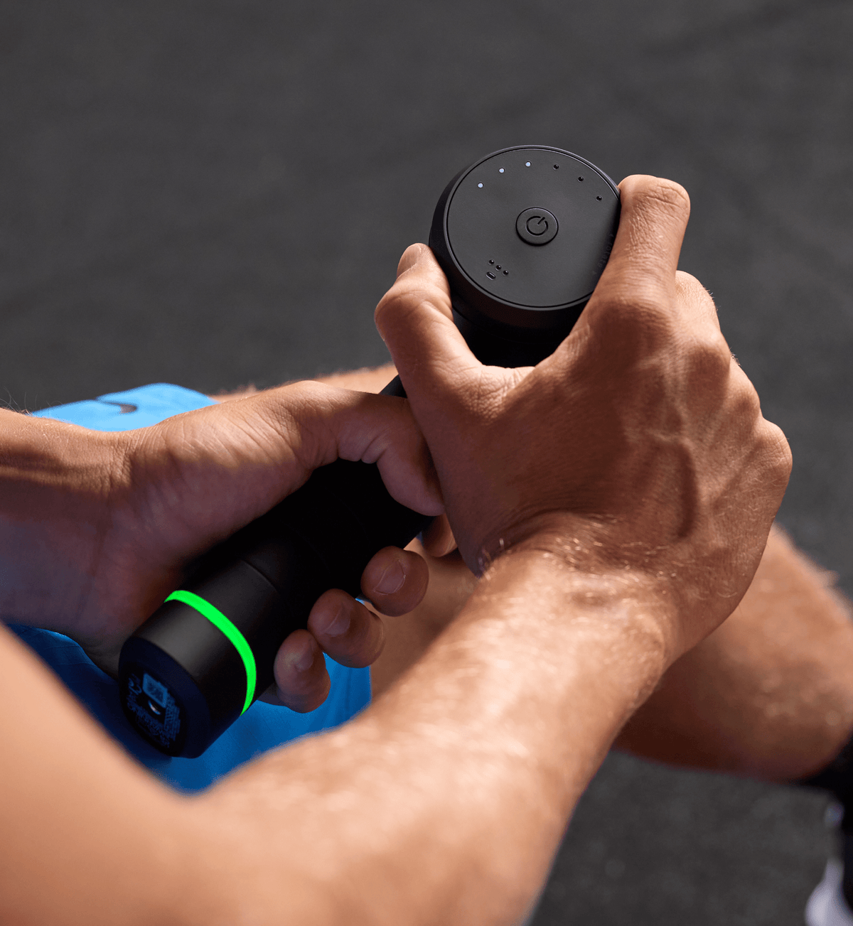 Close-up of the Hypervolt 3 Pro massage gun on the arm