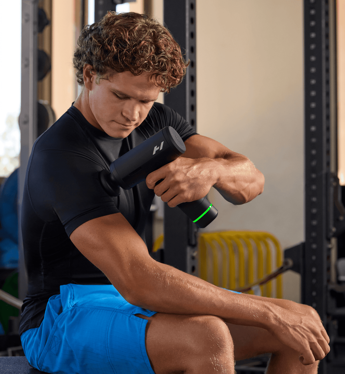 Man in a gym using the Hypervolt 3 Pro on his leg