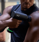 Athlete using the Hypervolt 3 Pro on his chest and shoulder