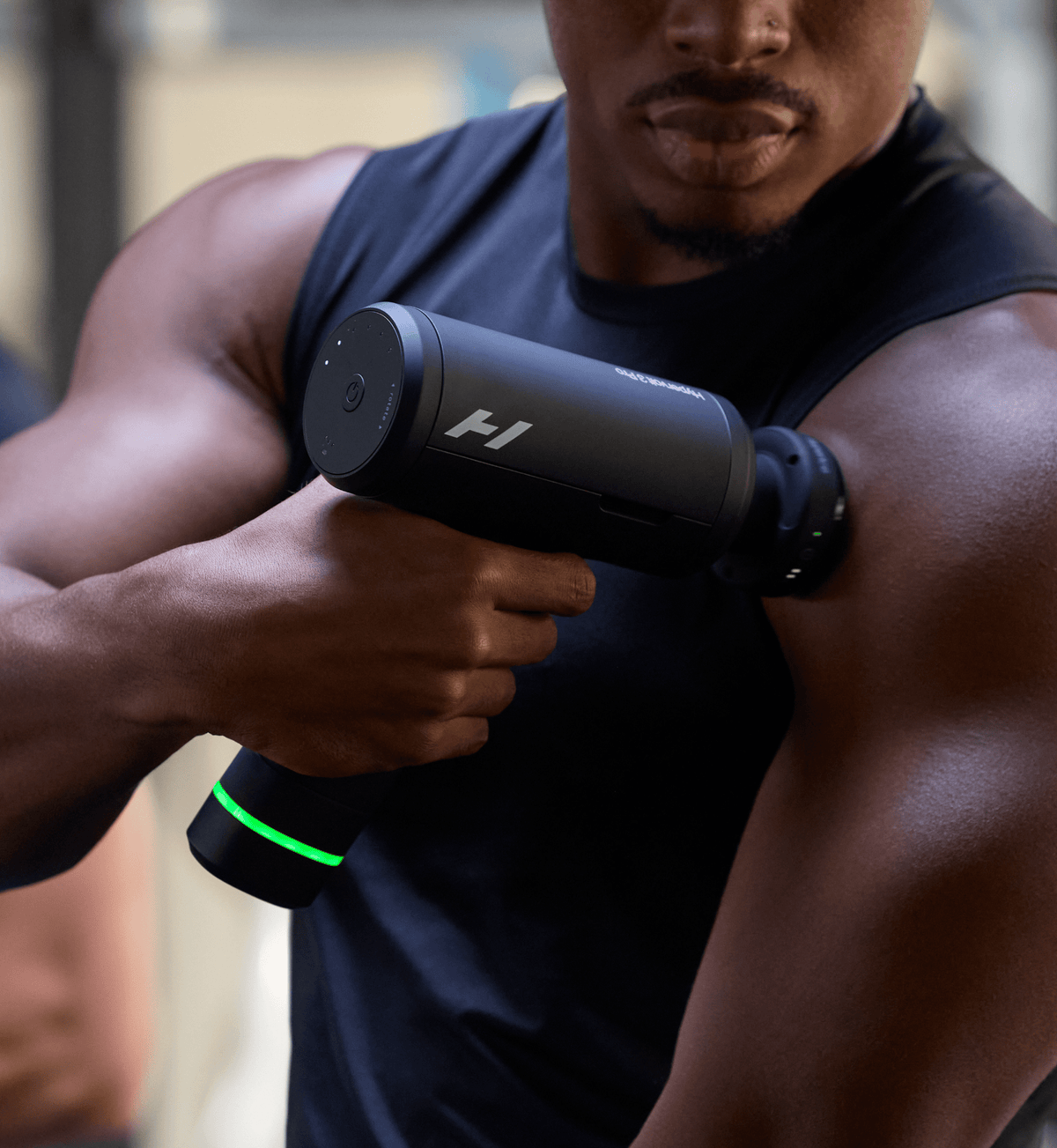 Athlete using the Hypervolt 3 Pro on his chest and shoulder